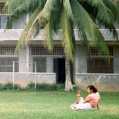 Mother and child outside Tuol Sleng (S-21 prison)