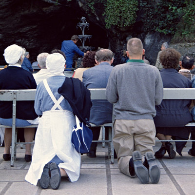 Praying at the cave, Lourdes, 1998