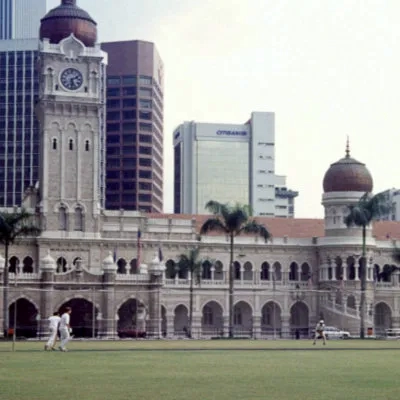 Playing cricket on Merdeka Square, Kuala Lumpur