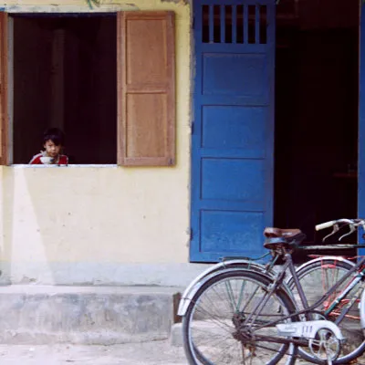 Child eating noodles in a window, Hoi An